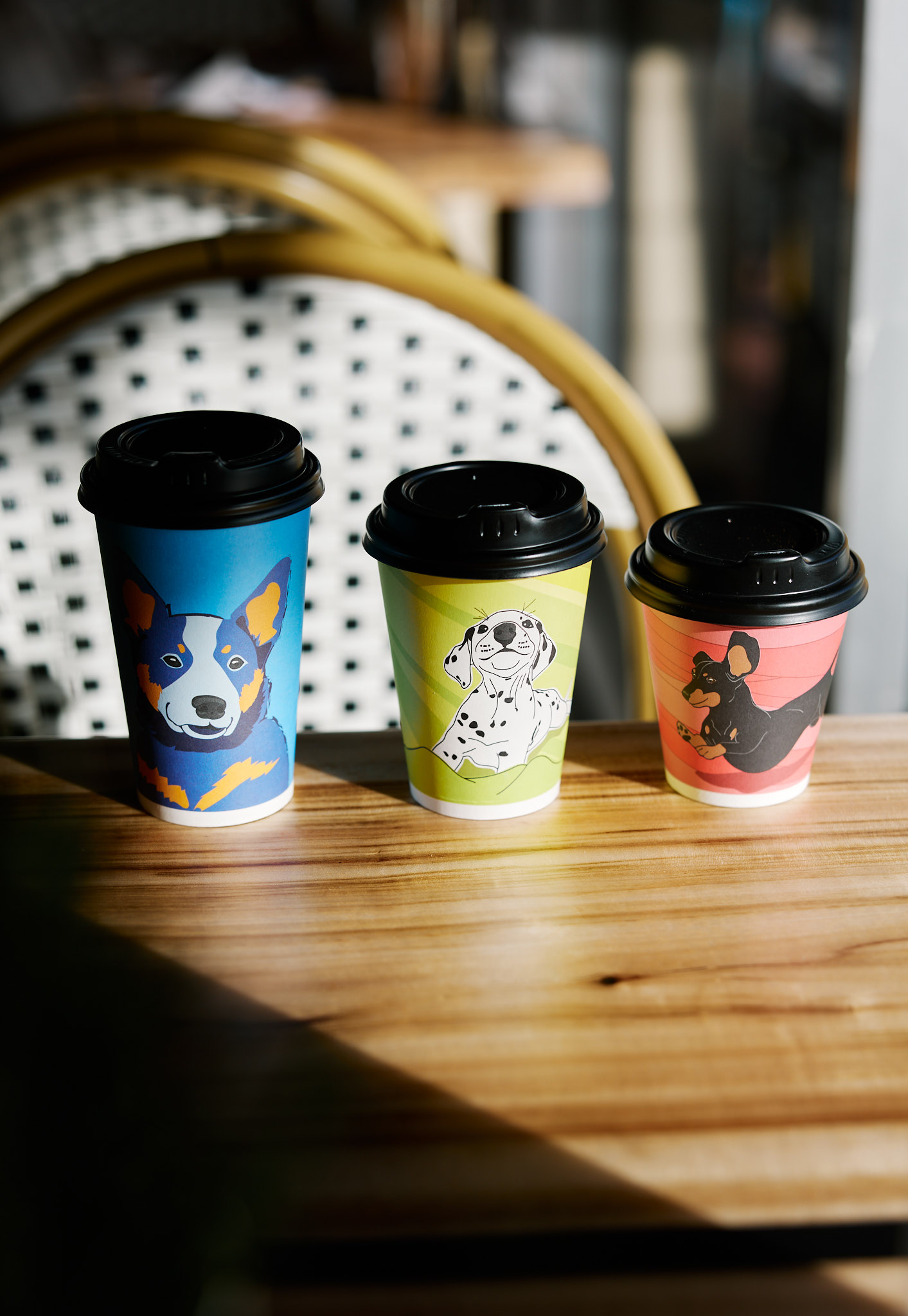 Mickle Pickle branded coffee cups with dog artwork