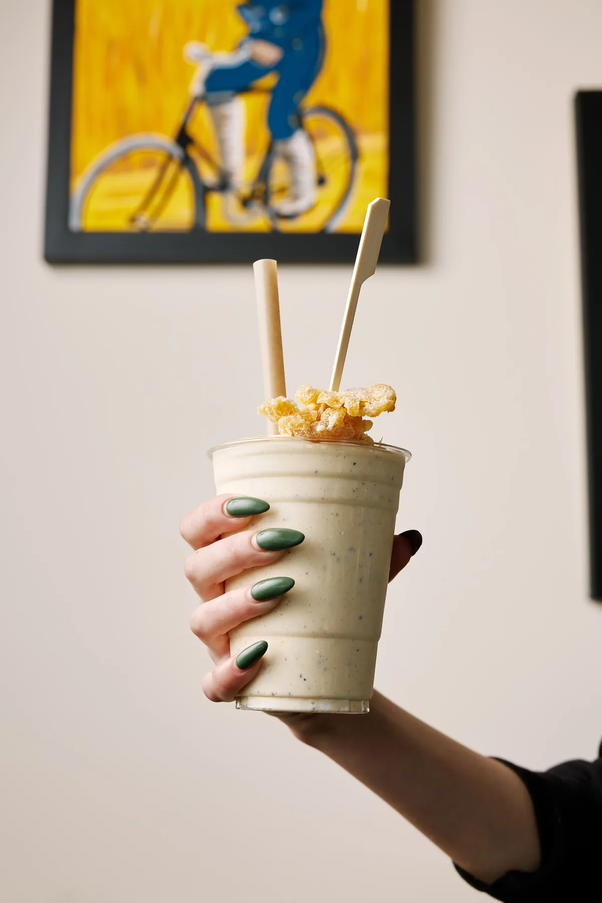 Thick milkshake held up in the cafe